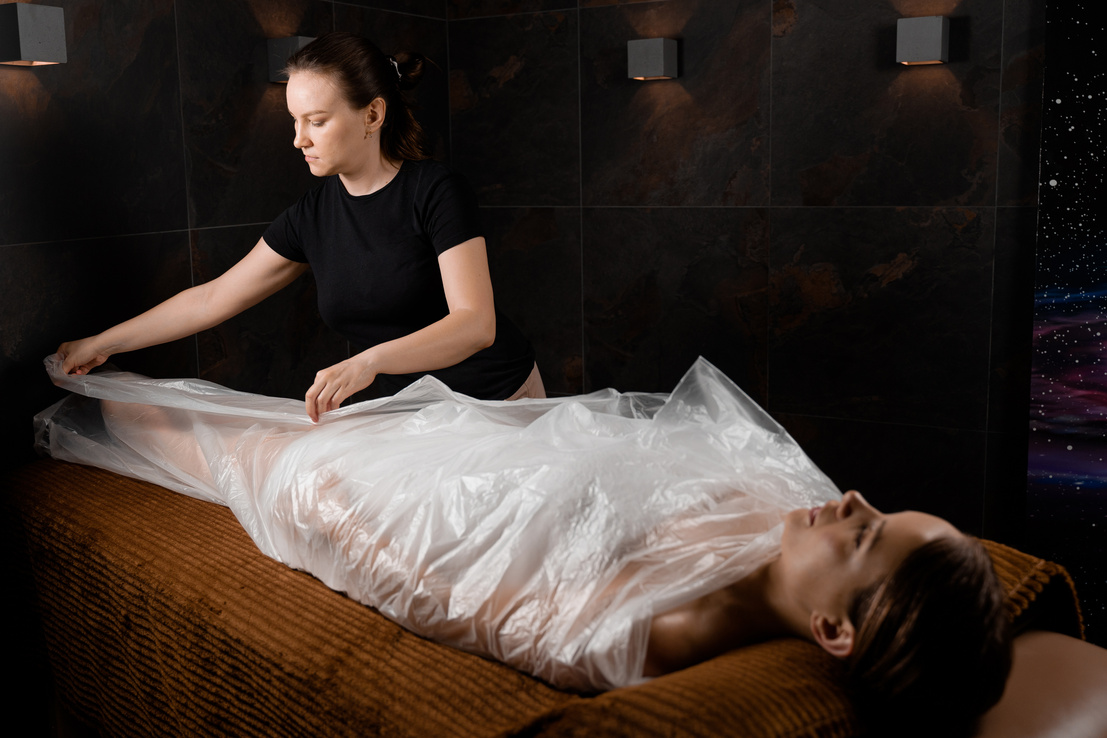 Woman wrapped in a polyethylene wrap. Chocolate Spa therapy